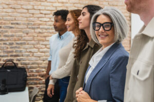A smiling brand representative with other professionals.