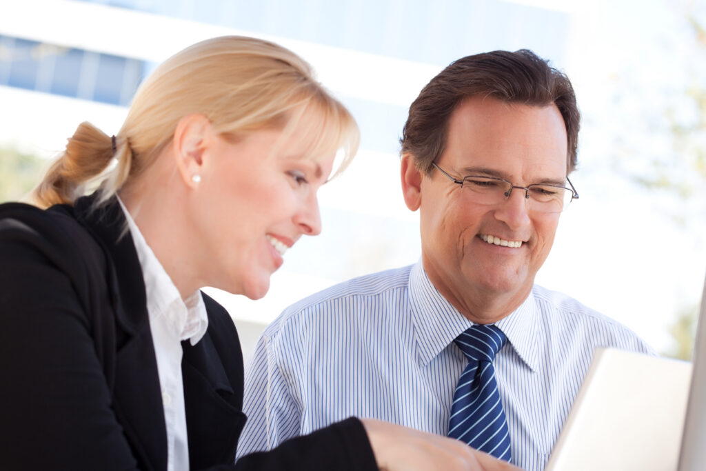 Two employees with professional attitude working together.
