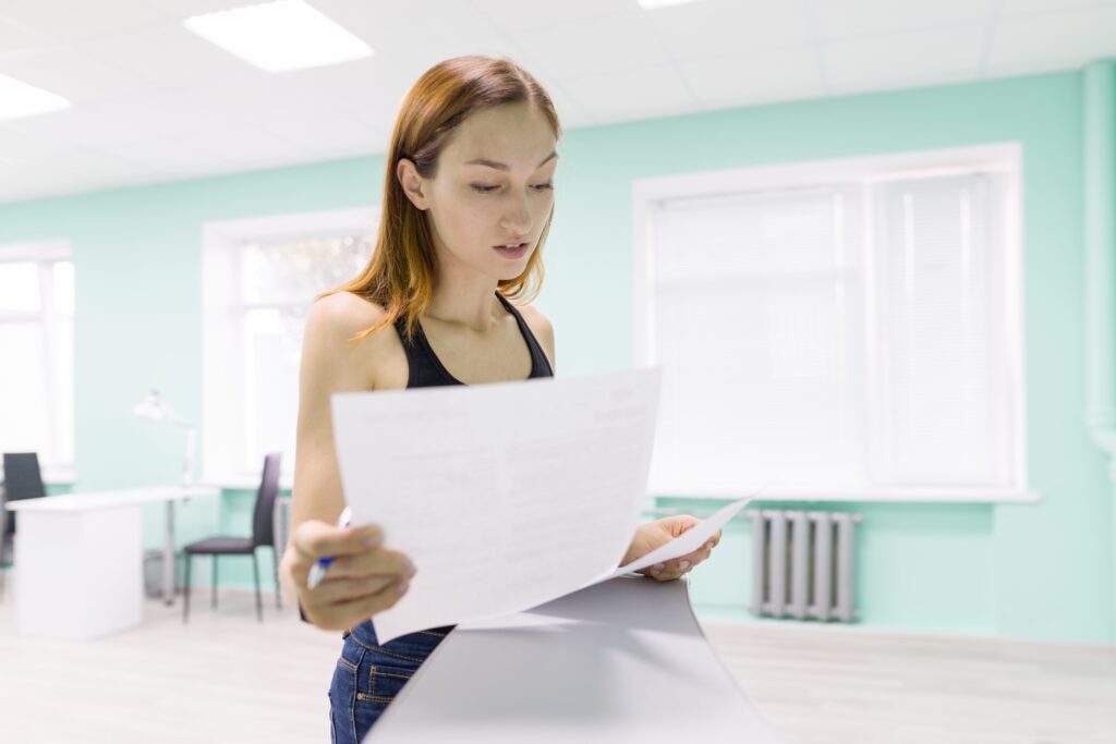 Sales professional holding a paper with marketing jargons.