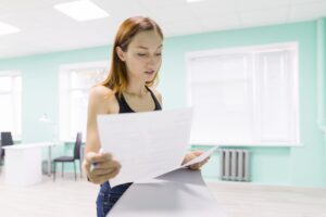 Sales professional holding a paper with marketing jargons.